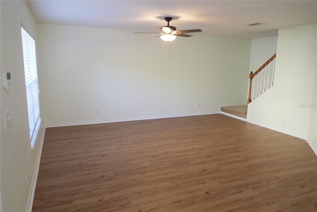 empty room featuring dark hardwood / wood-style flooring and ceiling fan