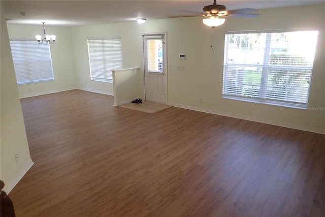 entrance foyer featuring ceiling fan with notable chandelier and dark hardwood / wood-style flooring