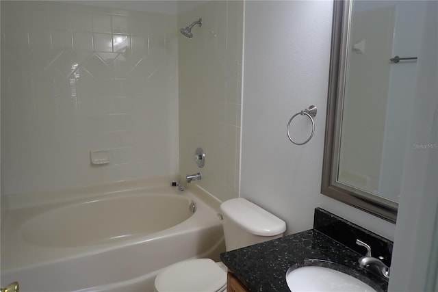 full bathroom featuring vanity, tiled shower / bath combo, and toilet