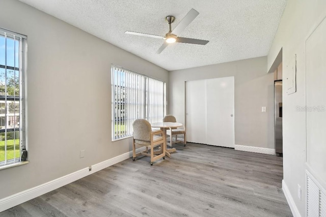 sitting room with a textured ceiling, light hardwood / wood-style floors, and ceiling fan