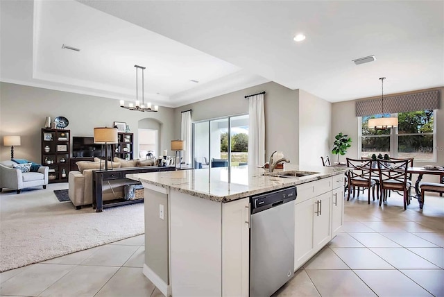 kitchen with dishwasher, decorative light fixtures, a center island with sink, and sink