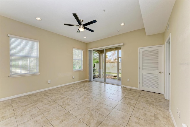 empty room with ceiling fan and light tile patterned flooring