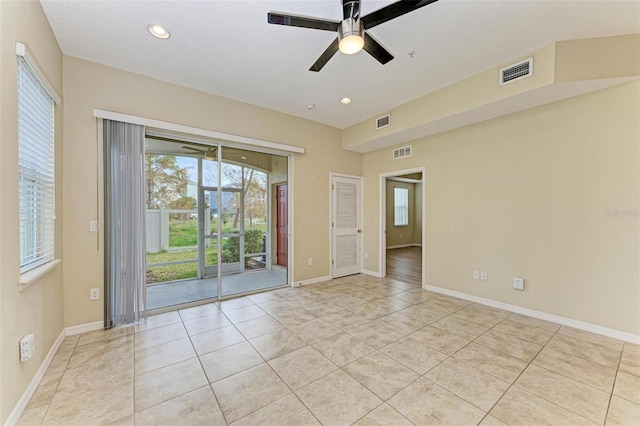 tiled empty room with ceiling fan