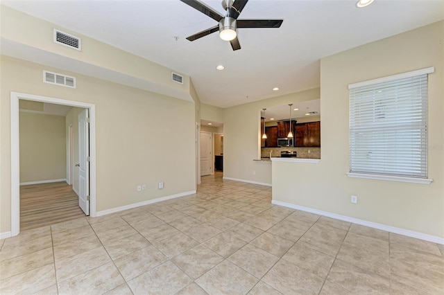 unfurnished living room with ceiling fan and light tile patterned flooring