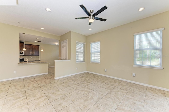 tiled empty room with ceiling fan