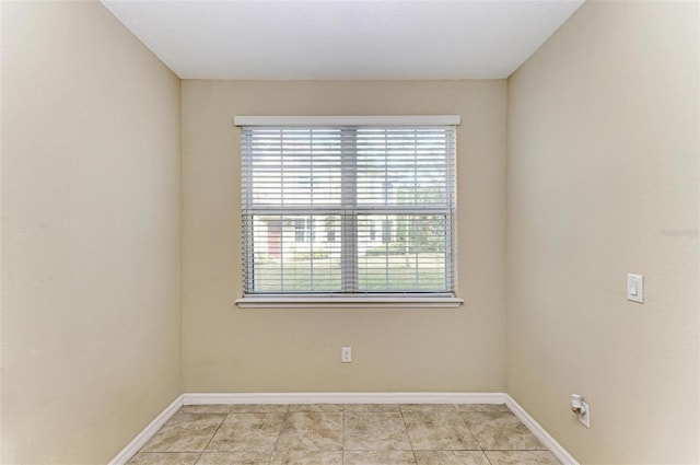 spare room featuring light tile patterned floors