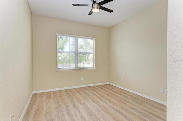 empty room with ceiling fan and light hardwood / wood-style flooring