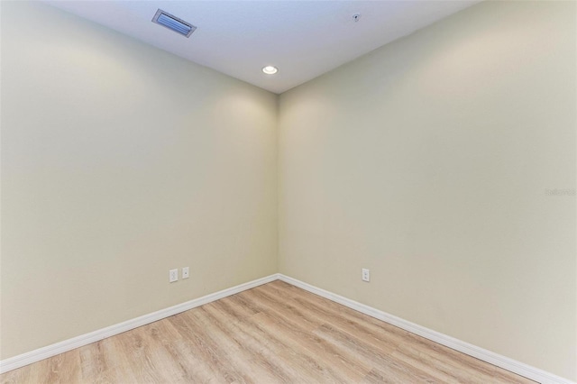 spare room with light hardwood / wood-style flooring