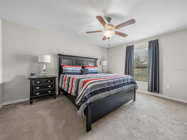 bedroom with carpet flooring, ceiling fan, and a textured ceiling