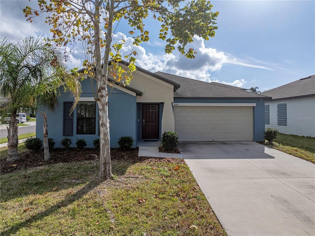 single story home with a garage and a front lawn