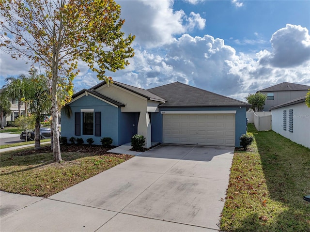 ranch-style home featuring a garage and a front lawn