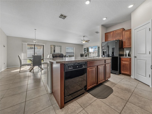 kitchen with sink, decorative light fixtures, a center island with sink, black appliances, and ceiling fan with notable chandelier