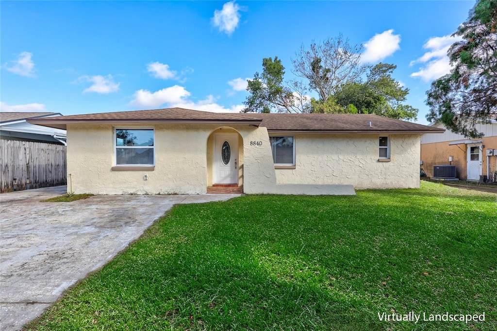 view of front of property with central AC and a front yard