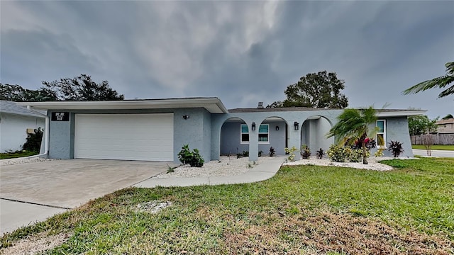 single story home featuring a front yard and a garage