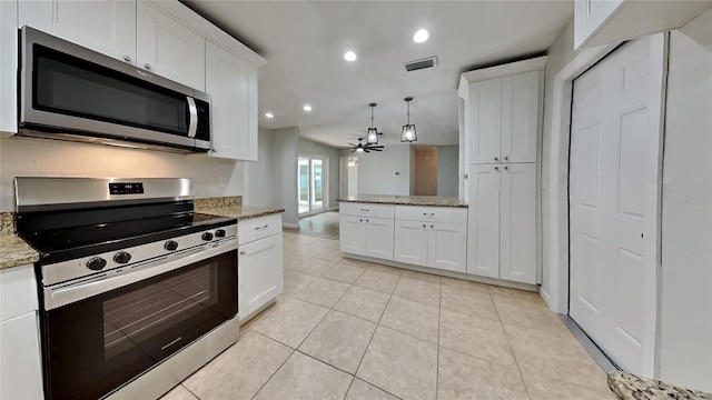 kitchen featuring ceiling fan, white cabinets, stainless steel appliances, and light stone counters