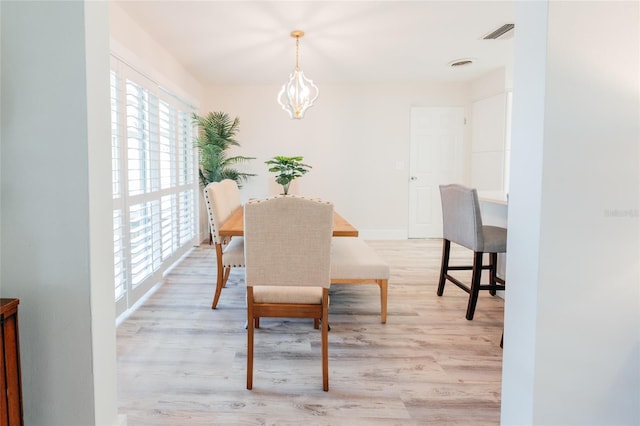 dining area featuring a chandelier and light hardwood / wood-style flooring