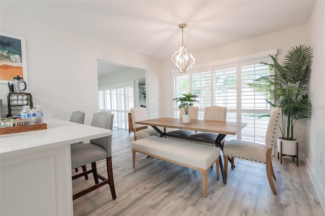 dining room featuring a wealth of natural light, a chandelier, and light wood-type flooring