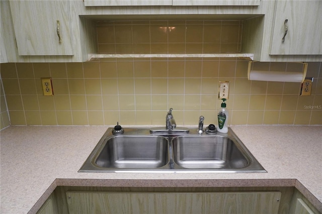 kitchen featuring sink, light brown cabinetry, and tasteful backsplash