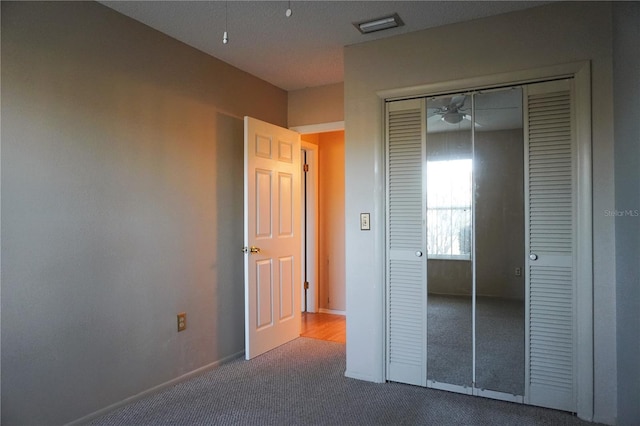 unfurnished bedroom featuring carpet floors and a closet