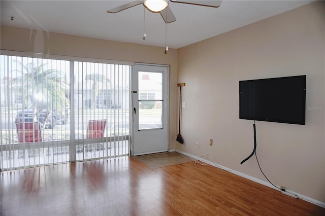 unfurnished living room with hardwood / wood-style flooring and ceiling fan