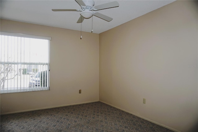 carpeted spare room with ceiling fan