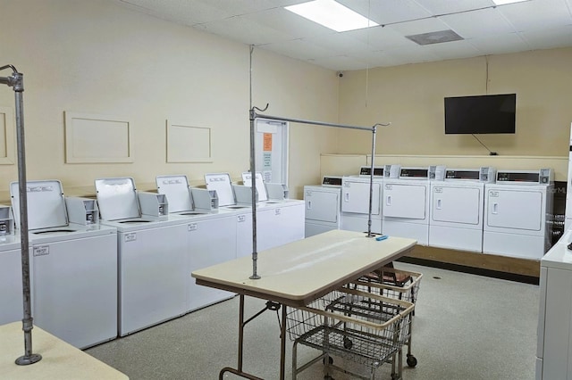 laundry area with washer and clothes dryer and light colored carpet