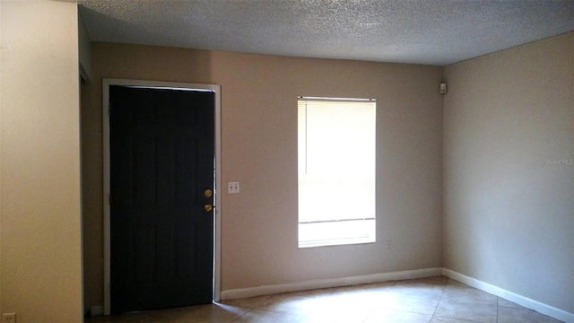 foyer with a textured ceiling and a wealth of natural light