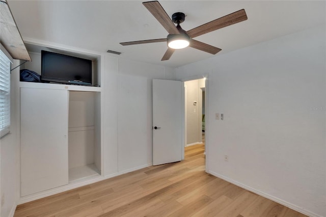 unfurnished bedroom featuring ceiling fan, a closet, and light hardwood / wood-style floors