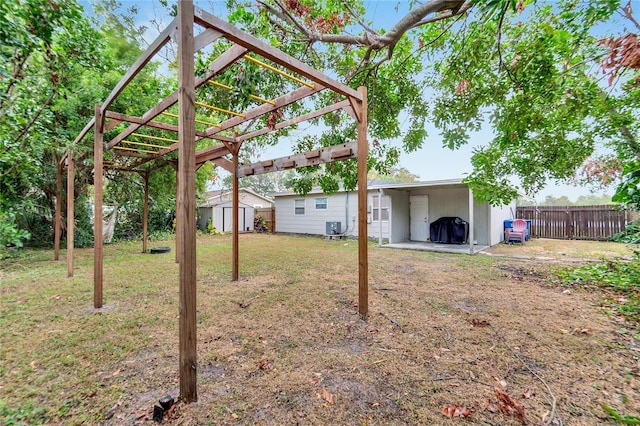 view of yard featuring a pergola and a storage shed