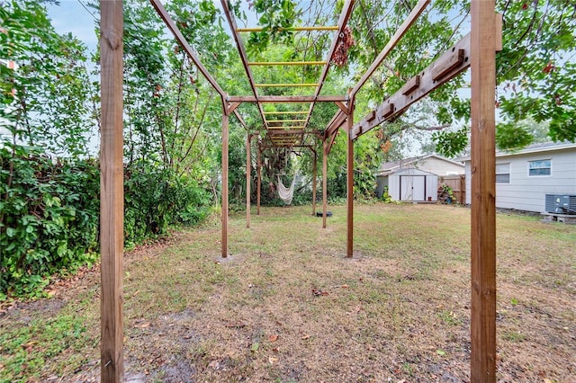 view of yard with a storage shed and central air condition unit