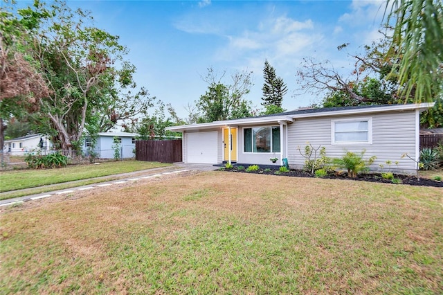 single story home featuring a garage and a front lawn