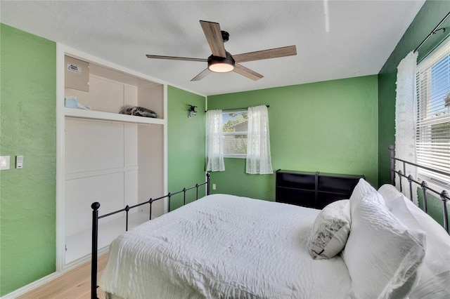 6524 14th St N, Saint Petersburg, FL 33702 - bedroom with wood finished floors, a closet, a ceiling fan, baseboards, and a textured wall