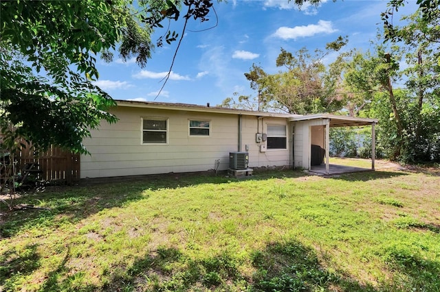 6524 14th St N, Saint Petersburg, FL 33702 - back of house with central air condition unit and a carport