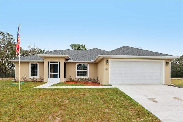 view of front of property with a front yard and a garage