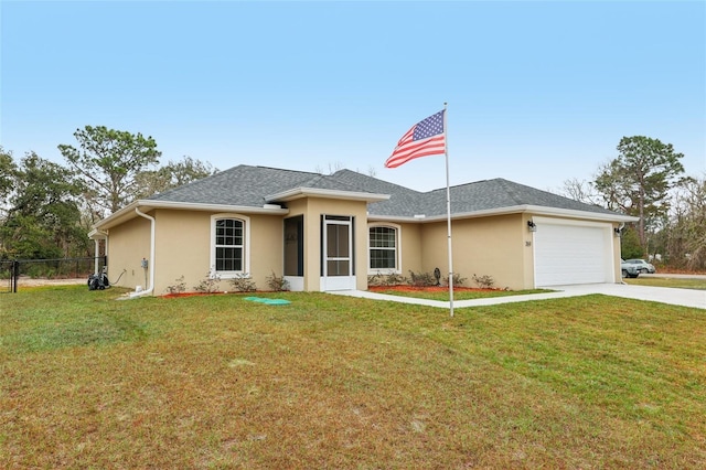 view of front of property with a front yard and a garage