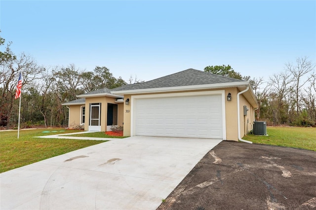 single story home with a front lawn, central AC unit, and a garage