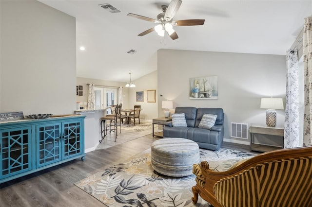 living room featuring lofted ceiling, ceiling fan, and wood-type flooring