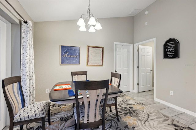 dining room featuring vaulted ceiling, light tile patterned flooring, and an inviting chandelier