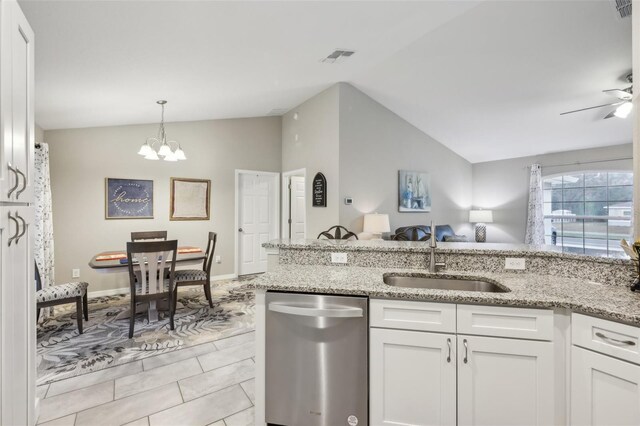 kitchen featuring stainless steel dishwasher, sink, light stone countertops, and white cabinets