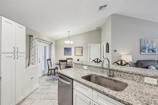 kitchen with light stone countertops, sink, vaulted ceiling, stainless steel dishwasher, and white cabinets