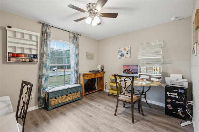 home office with hardwood / wood-style flooring and ceiling fan