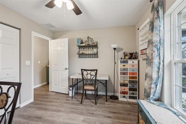 living area with ceiling fan and wood-type flooring