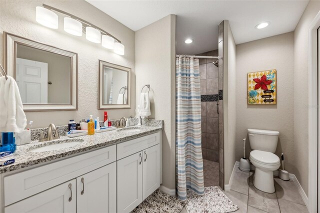 bathroom featuring toilet, tile patterned flooring, a shower with shower curtain, and vanity