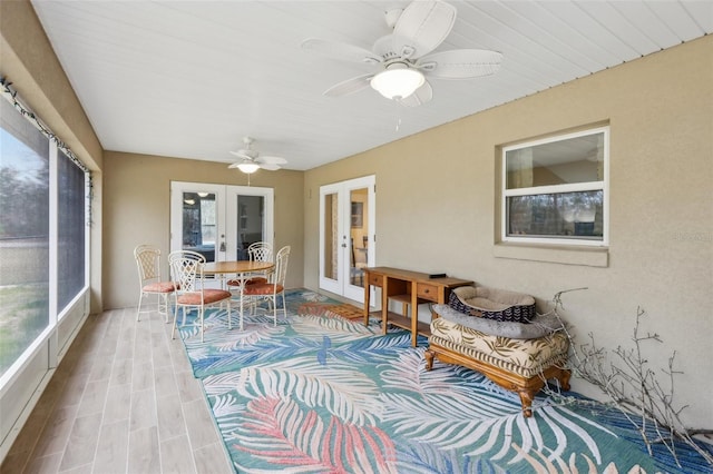 sunroom featuring french doors and ceiling fan