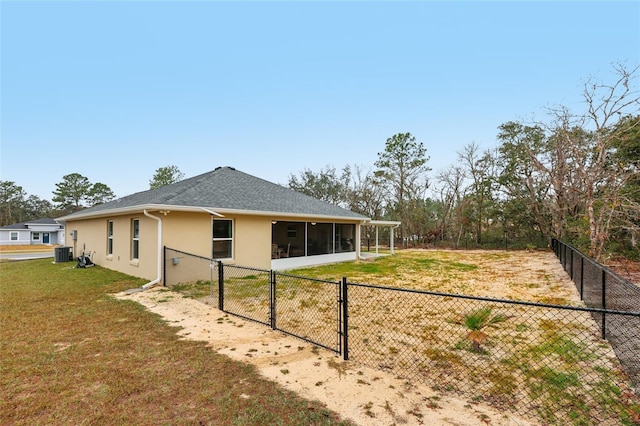 view of property exterior with central AC, a yard, and a sunroom