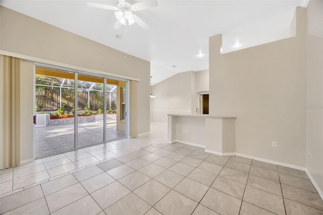 tiled empty room featuring ceiling fan and lofted ceiling