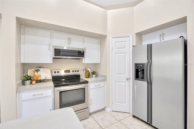 kitchen featuring white cabinetry, light tile patterned floors, and appliances with stainless steel finishes