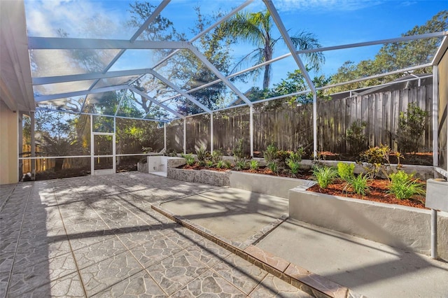 view of patio with glass enclosure