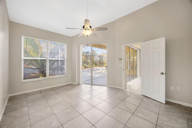 tiled spare room featuring ceiling fan