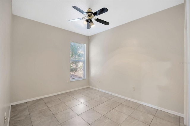 tiled spare room with ceiling fan